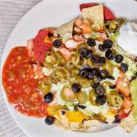 Nachos Supreme · Spicy beef or chicken, lettuce, tomato, jalapeños, olives with sour cream, salsa, and guacam...