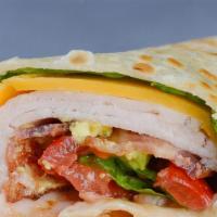 Turkey Wrap · Thin deli turkey is wrapped in a whole wheat tortilla with avocado, Swiss cheese, and crumbl...