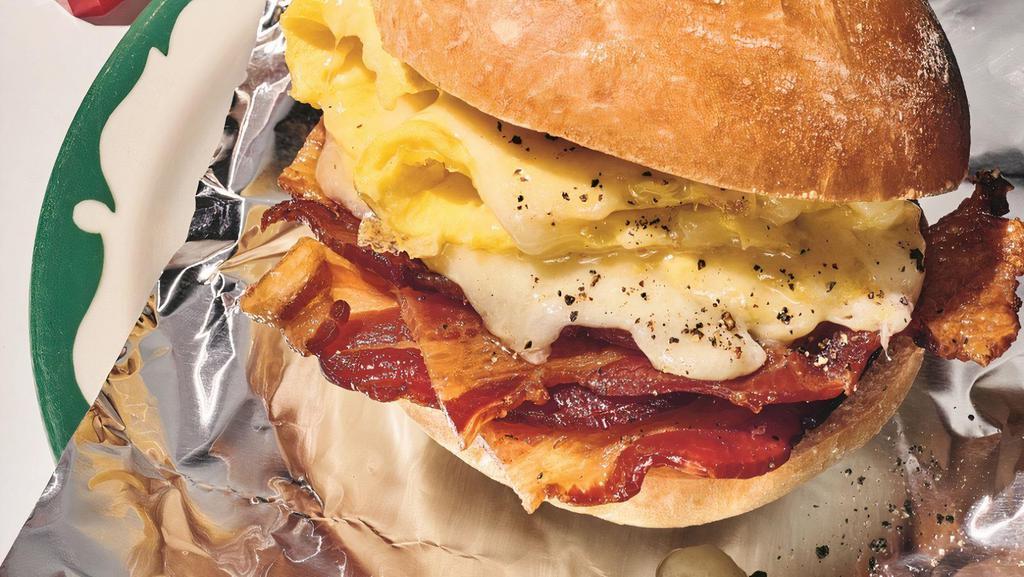 Bacon With Egg & Cheese · The bacon egg and cheese sandwich is how New Yorkers start their day! Fried or scrabble eggs, bacon, and melted yellow American cheese or the cheese to your liking on a deli roll or hero price subject to change