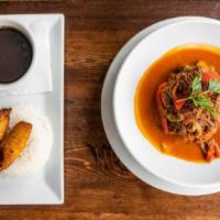 Ropa Vieja · Most popular. Traditional slow-cooked shredded beef, onions, and peppers. Served with white ...