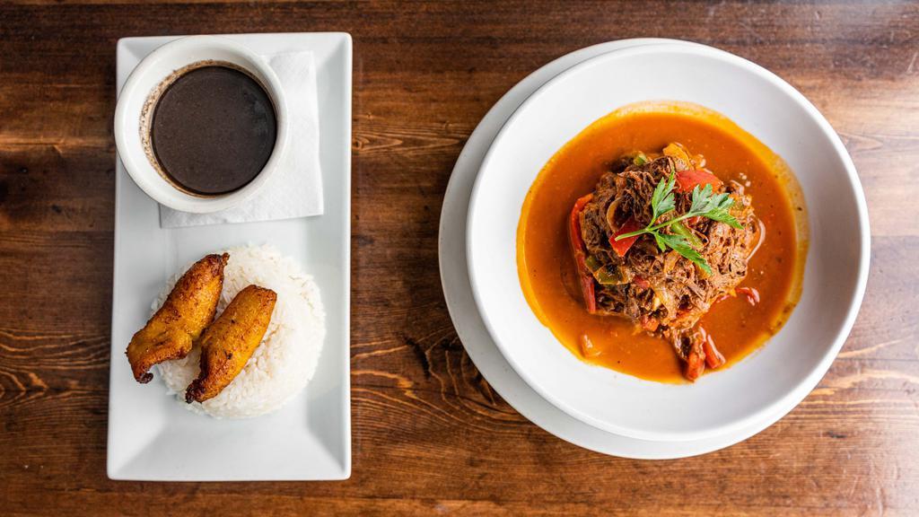 Ropa Vieja · Most popular. Traditional slow-cooked shredded beef, onions, and peppers. Served with white rice, black beans, and maduros.