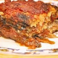 Parmigiana Di Melanzane · Eggplant layered with mozzarella cheese and tomato sauce sprinkled with parmesan cheese