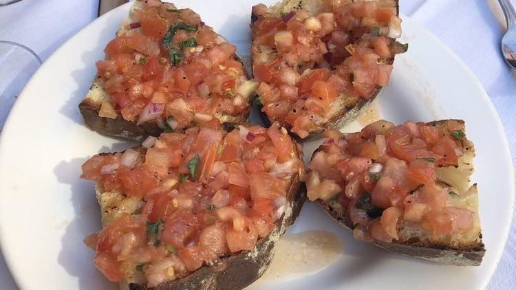 Bruschetta Al Pomodoro · Bread toasted with cherry tomatoes, basil, and olive oil