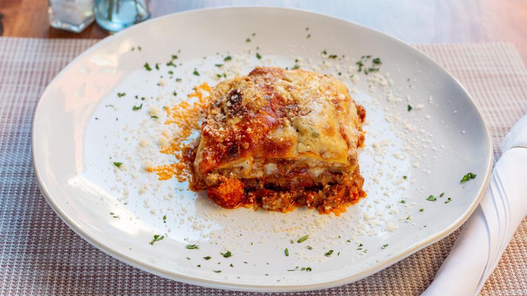 Lasagna Al Forno · Homemade lasagna made with bolognese ragu (beef) bechamel sauce, mozzarella, and parmesan cheese