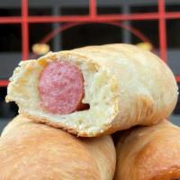 Houston Style Beef Sausage · Whole beef sausage link wrapped in slightly sweet kolache dough