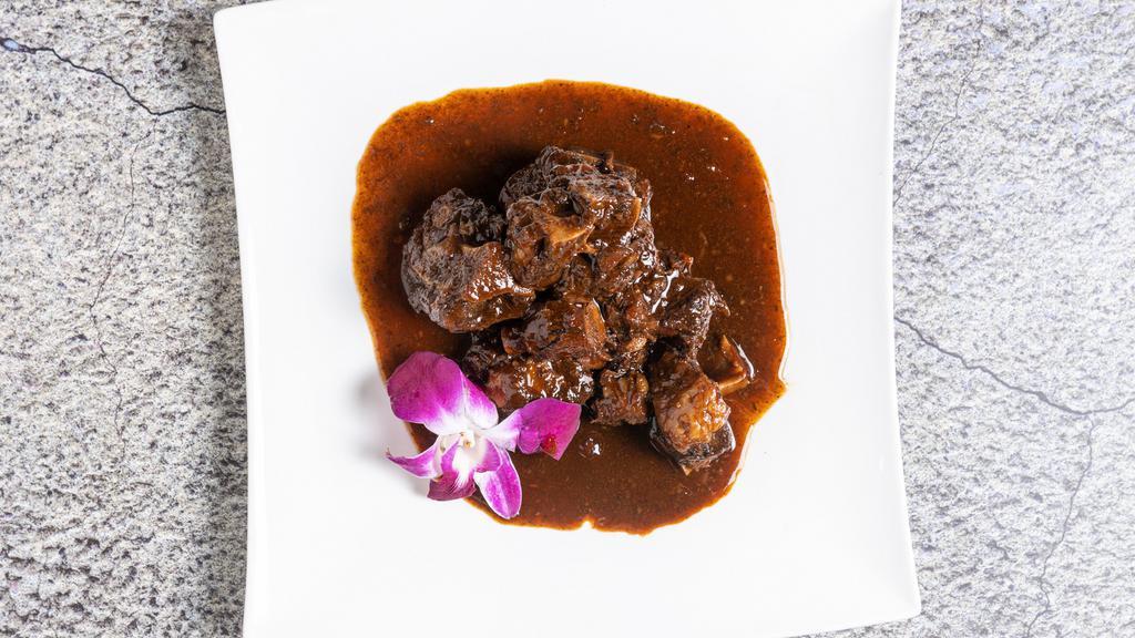 Oxtail · Served with steam vegetables, sweet plantains and a choice of rice or mash potatoes.