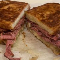 Rueben  · Hot corned beef or pastrami on grilled rye with Swiss, sauerkraut and Thousand Island dressi...
