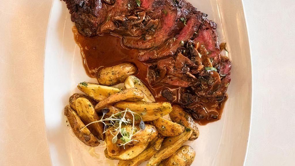 Hanger Steak · Grilled steak with roasted ﬁngerling potatoes tossed with gremolata brandy mushroom sauce.