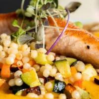 Grilled Salmon  · Pan seared salmon over pearl couscous, roasted mixed vegetables, carrot puree sauce.