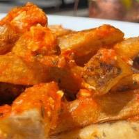 Greek Rigani Fries · Hand cut fries, tossed in a garlic oil, parmesan, oregano, and feta sauce.