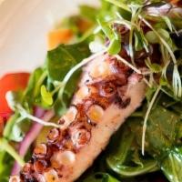 Grilled Octopus · Charred leg of octopus on a bed of arugula, ﬁngerling potatoes, tomatoes, red onion, olives,...
