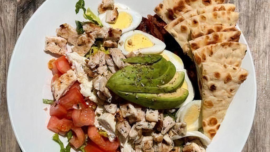 Tru Cobb Salad · Chopped romaine lettuce, tomatoes, hard boiled eggs, avocado, smoked bacon, feta cheese, grilled chicken, lemon and olive oil dressing.