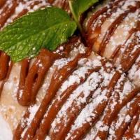 Nutella Royale Crepe · Crepe filled with nutella, bananas, strawberries, and topped with powdered sugar
