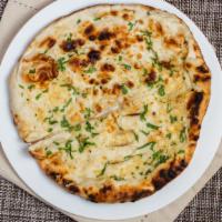 Garlic Naan · Vegan. Garlic and cilantro crusted flatbread, cooked in the clay oven.