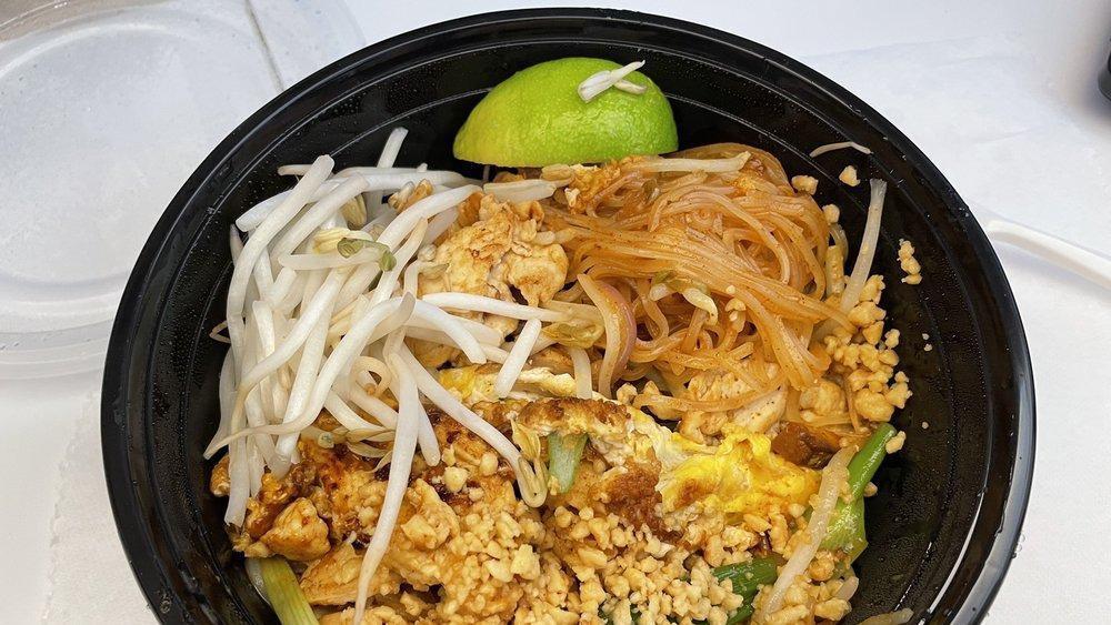 Pad Thai · Stir-fried Thai rice noodles with brown tofu, eggs, bean sprouts, scallions and crushed peanuts.