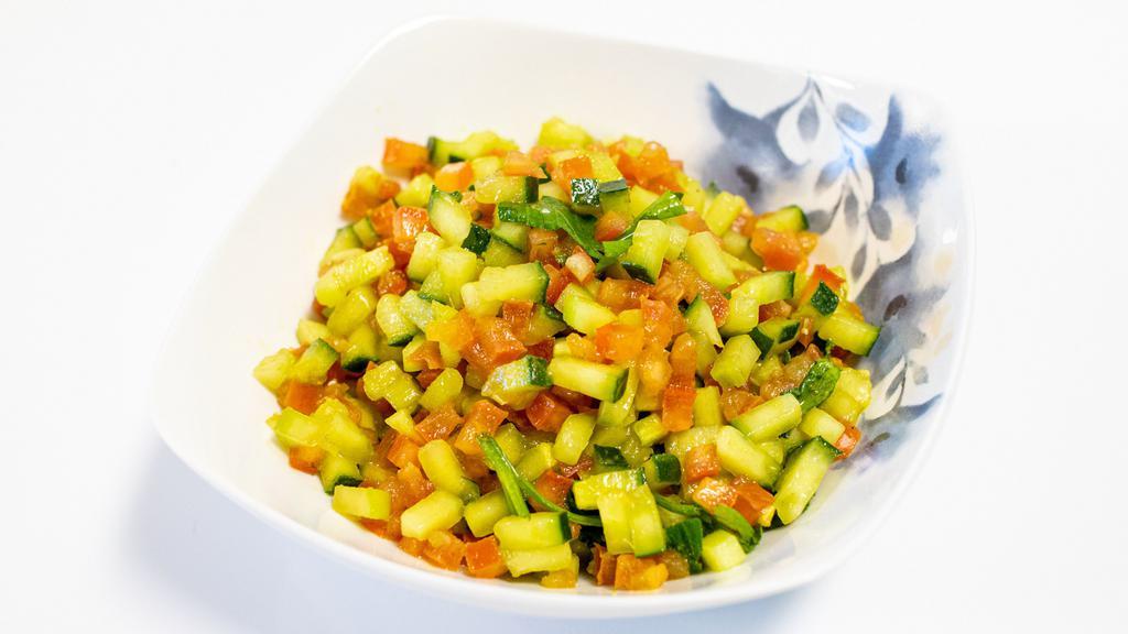 Kachumber Salad · Sweet-tangy tomatoes, crunchy cucumbers and piquant onions go well with almost any Indian dish. Having some fresh, raw veggies with your meal or as a meal with tandoori chicken, cilantro chicken, or plant-based burger without bun for additional charge.