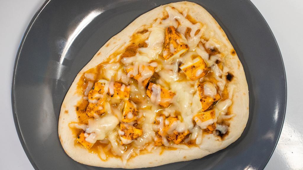 Paneer Tikka Naan Pizza · This naan pizza has our signature tikka sauce, tandoori paneer and mozzarella cheese.