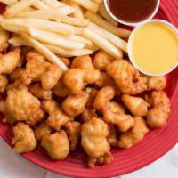 Popcorn Chicken Combo · Comes with two sauces on the side. Includes medium fries and a canned drink.