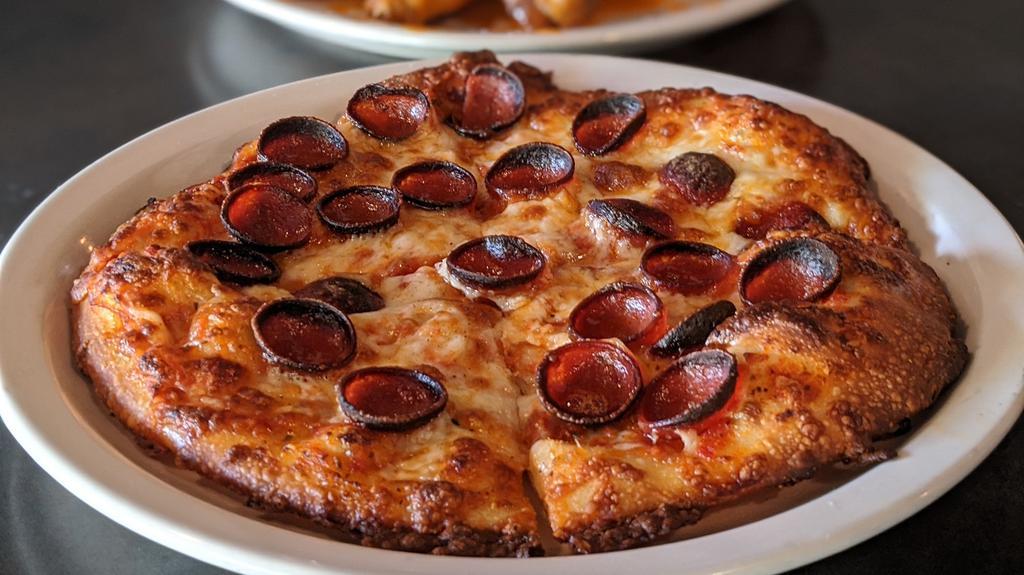 Bee Sting Personal Pizza · This personal pizza is topped with mozzarella, pepperoni and drizzled with our hot honey sauce for a little sweet and heat finish