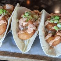 Bang Bang Shrimp Tacos · Three tacos topped with homemade slaw, crispy shrimp, green onions and finished with a our s...