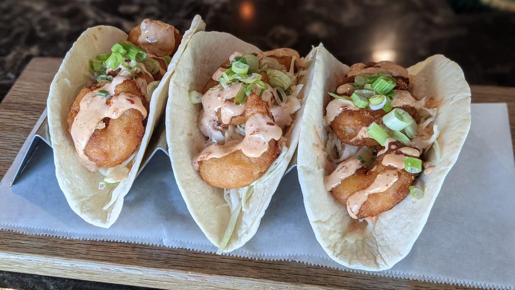 Bang Bang Shrimp Tacos · Three tacos topped with homemade slaw, crispy shrimp, green onions and finished with a our spicy Thai Bang Bang sauce