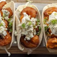 Buffalo Shrimp Tacos · Three crispy battered shrimp tacos drizzled in your choice of Buffalo sauce a top crisp cabb...
