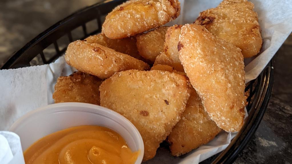 Mac & Cheese Bites · Crispy fried Mac & Cheese bites served with a side of our homemade Buffalo sauce