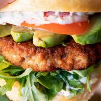 Salmon Burger · With avocado, sliced tomato, arugula, and tartar sauce on a toasted Clinton St. kaiser bun, ...