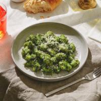 Gnocchi Pesto · Fluffy gnocchi tossed in a savory pesto sauce and topped with fresh Parmesan cheese.