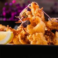 Ika Karaage (Fried Calamari ) · Fried squid rings and tentacles with lemon paired with spicy mayo sauce