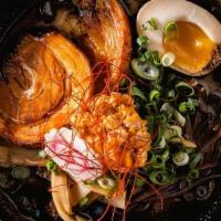 Kuro Ramen · Chashu, black fungus, bamboo shoots, scallions, fish cake, half cooked egg, topped with spic...