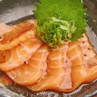 Salmon Carpaccio · Salmon and scallion with wasabi dressing.