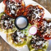 Chalupas · Small tortilla cooked in Manteca, topped with salsa verde or roja, onions, cheese and beef.