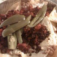 Chorizo Nachos · Mexican sausage. Served with beans, cheese, sour cream and jalapenos.