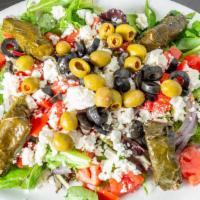 Greek Salad · Mixed greens, tomatoes, onions, green olives, black olives, cucumbers, feta, stuffed grape l...