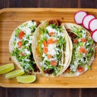 Taco Regular · Choice of filling with onion and cilantro on soft corn tortilla.