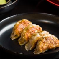Pork Gyoza · Grilled Japanese Pork Dumplings, Finished with a Sweet and Sour Sauce and Fresh Black Pepper