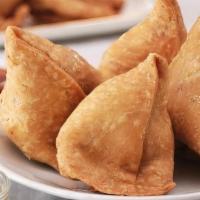 Vegetable Samosas · 2 pastries stuffed with delicately spiced potatoes and peas then deep fried.