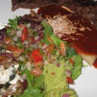 Bistec Con Nopales Platillo · Steak cooked with cactus leaf served with rice and refried beans on the side.