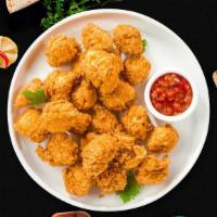 Chicken Popcorn · Bite-size pieces of chicken breaded and fried until golden brown.