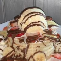 Strawberry, Banana & Nutella Pancakes · A fruity delight, these pancakes come with slices of fresh strawberries and bananas.  Comes ...