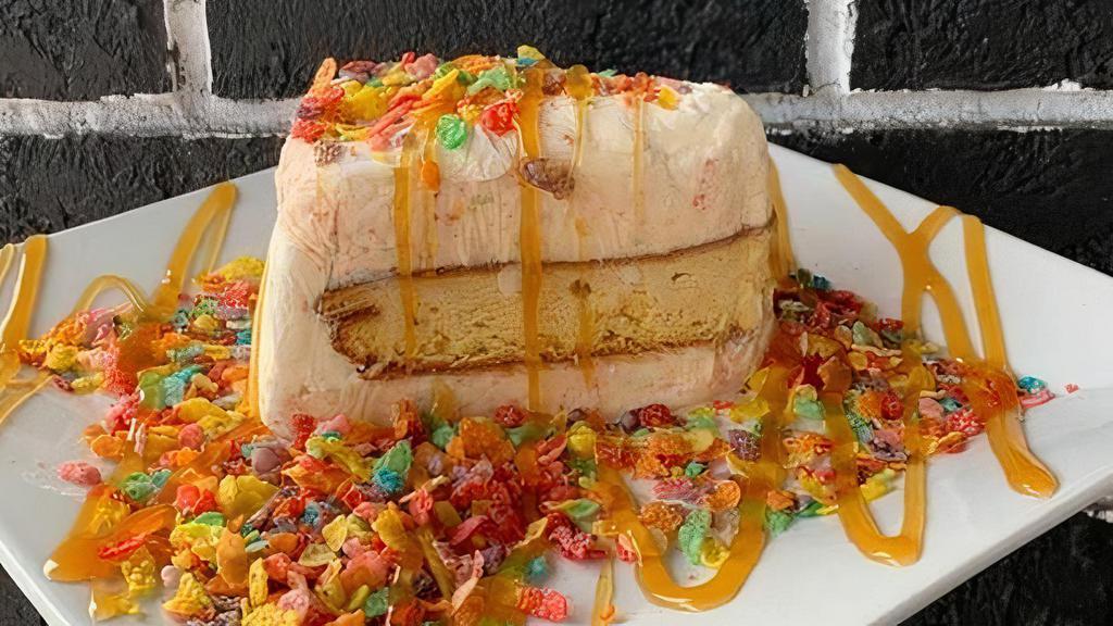 Fruity Pebbles ® Ice Cream Cake · A rainbow delight; our Fruity Pebbles ® ice cream paired with vanilla cake.  Comes topped with caramel drizzle and pieces of Fruity Pebbles ® cereal.