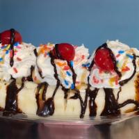 Banana Split · 3 scoops between a halfed banana topped with whipped cream, sprinkles, cherries an drizzled ...