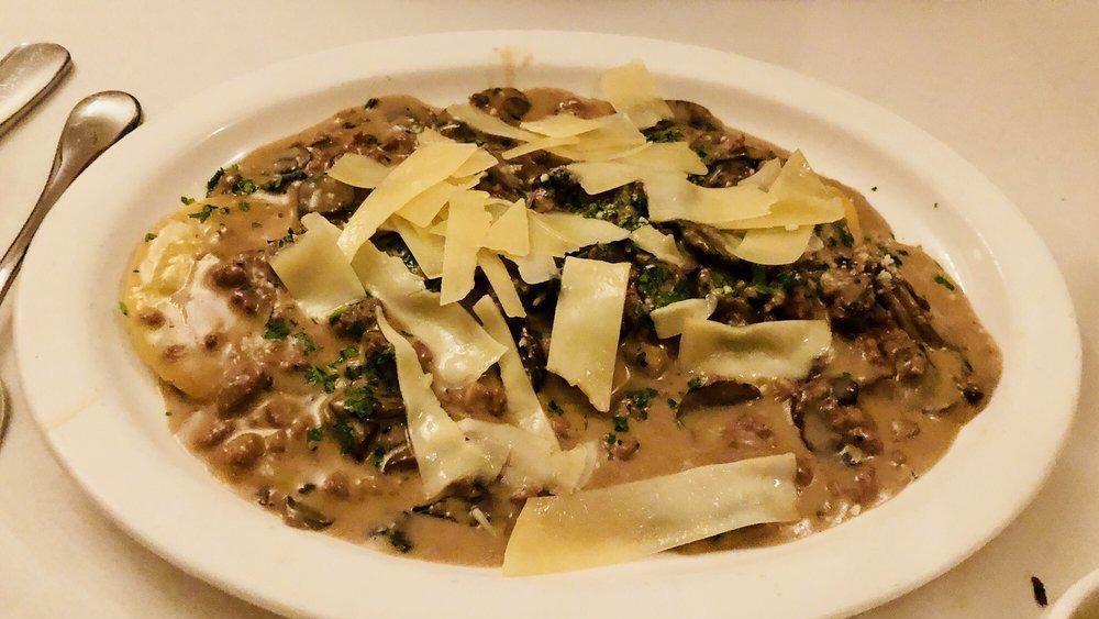 Agnolotti Pulcinella · Homemade half moon shape pasta stuffed with ricotta and spinach in light brown sauce, dutch cream, crumbled sausage, mushroom and truffle oil.
