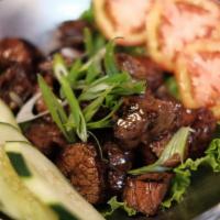 Bo Luc Lac · Marinated cubed sirloin beef wok-tossed with oyster sauce and black pepper.