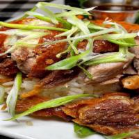 Roast Duck · Roast duck over rice topped with hoisin-garlic sauce with steamed yu choy and pickled carrot...