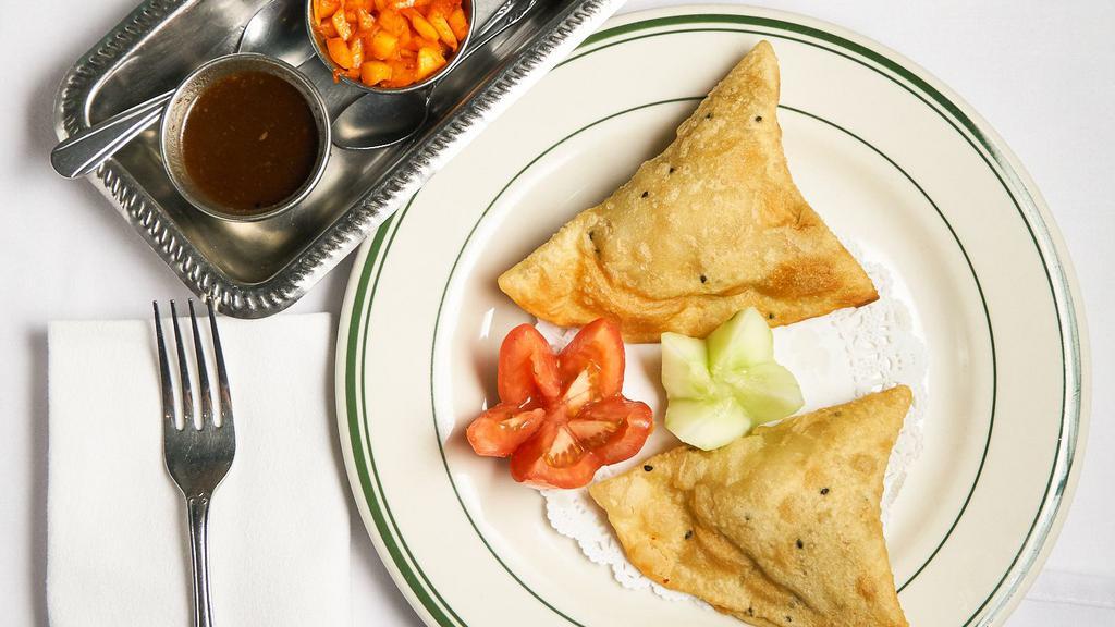 Vegetable Somosa (2 Pieces) · Crisp pastry turnover filled with vegetable.