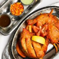 Tandoori Chicken · Spring chicken marinated in yogurt and spices, cooked in special oven.