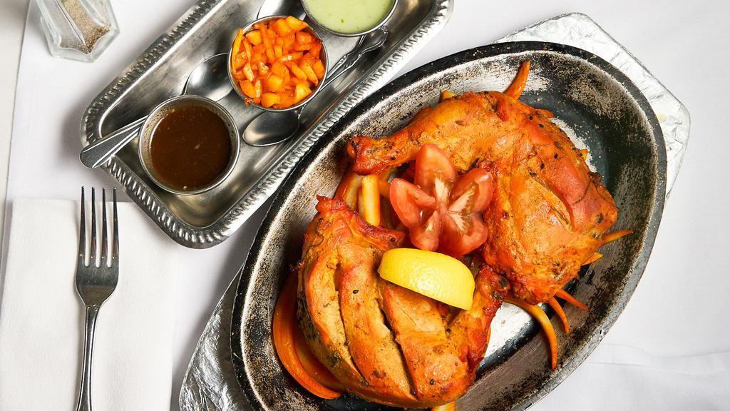 Tandoori Chicken · Spring chicken marinated in yogurt and spices, cooked in special oven.