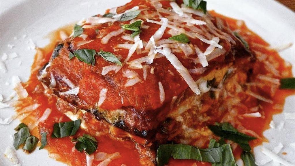 Eggplant Parmigiana · Baked with cheese.